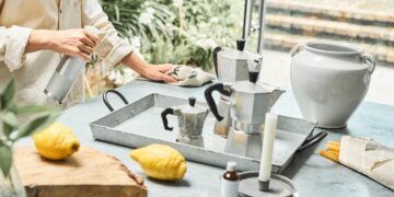 woman-cleaning-natural-products-unsplash - INDIAwebzine A woman in an Indian kitchen assembling a zero-chemical cleaning kit with lemon, baking soda, and vinegar on the counter