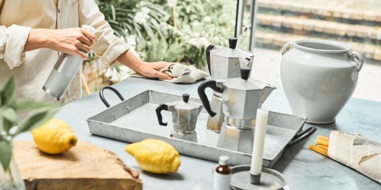 woman-cleaning-natural-products-unsplash - INDIAwebzine A woman in an Indian kitchen assembling a zero-chemical cleaning kit with lemon, baking soda, and vinegar on the counter