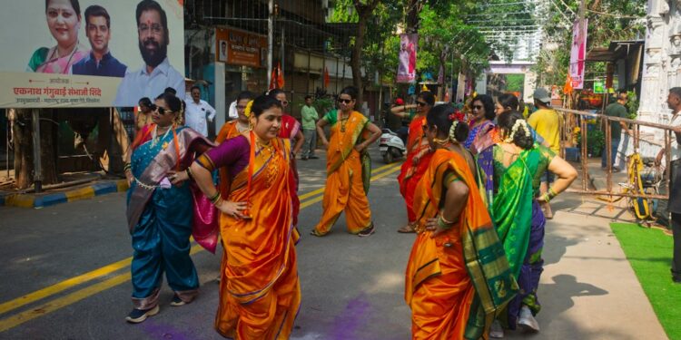 woman-dancing-garba-traditional-dress-unsplash - INDIAwebzine Women in an embroidered chaniya-choli spins during Navratri celebrations at a community Garba night