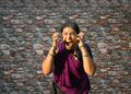woman-singing-carnatic-classical-india-unsplash - INDIAwebzine A female vocalist performing Carnatic music on stage at a South Indian concert hall