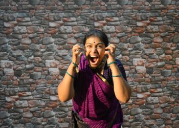 woman-singing-carnatic-classical-india-unsplash - INDIAwebzine A female vocalist performing Carnatic music on stage at a South Indian concert hall