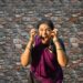 woman-singing-carnatic-classical-india-unsplash - INDIAwebzine A female vocalist performing Carnatic music on stage at a South Indian concert hall