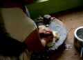 Woman preparing fermented foods batter in an Indian kitchen