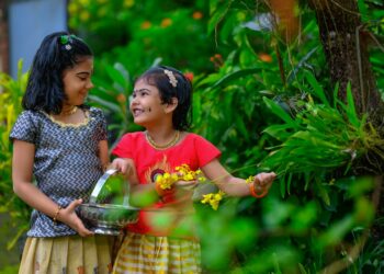 Host welcoming guests outside one of Kerala's backwater homestays