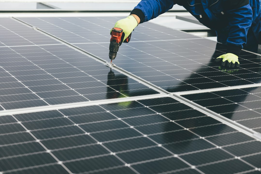 Technician installing rooftop solar panels on a residential roof in India