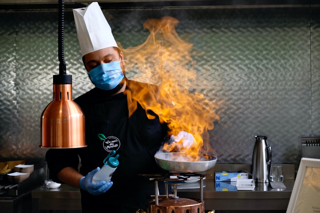 Un chef de origen indio sirve cuidadosamente un plato de curry con sabores del monzón en un restaurante moderno de Singapur.